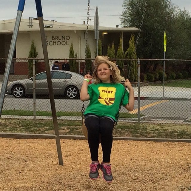 Unlimited awesomeness wristband (ride and play everything) and she's on the swings at Family Fun Night :)