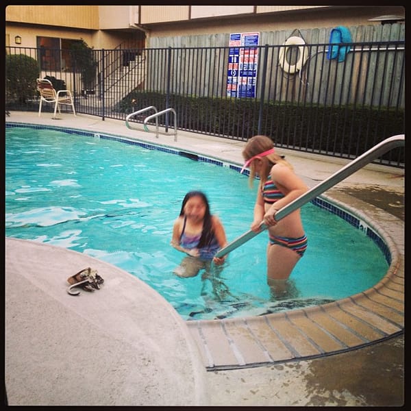 Working poolside watching my daughter and her friend freeze their butts off.