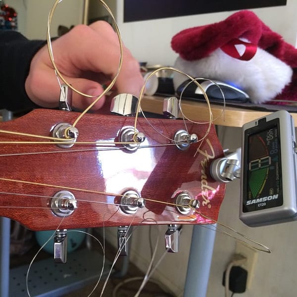 Chris using the new guitar tuner I got him.