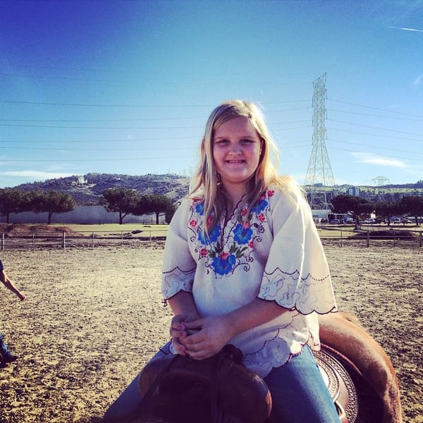 Jessalyn stops for a picture while riding a horse at Kenna's Birthday. Thanks @stephanieholub4 ;)