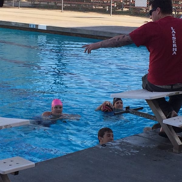 Coach talking to the kids on how to play a game for practice