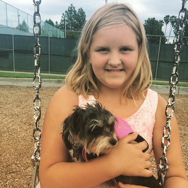 Jess and Twinkle swinging at the park