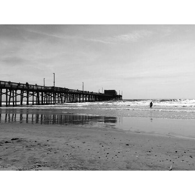 Playing in the waves at Newport Pier Feature image